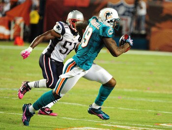 MIAMI - OCTOBER 4: Brandon Marshall #19 of the Miami Dolphins runs with a catch against the New England Patriots at Sun Life Field on October 4, 2010 in Miami, Florida. (Photo by Scott Cunningham/Getty Images)