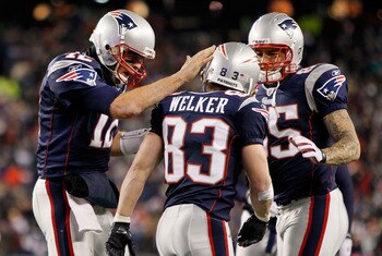 FOXBORO, MA - DECEMBER 06:  (L-R) Tom Brady #12, Wes Welker #83 and Aaron Hernandez #85 of the New England Patriots celebrate after Welker scored a touchdown in the third quarter against the New York Jets at Gillette Stadium on December 6, 2010 in Foxboro