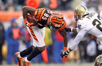 CINCINNATI, OH - DECEMBER 05:  Chad Ochocinco #85 of the Cincinnati Bengals is tackled by Tracy Porter#22 of the New Orleans Saints during the NFL game at Paul Brown Stadium on December 5, 2010 in Cincinnati, Ohio.  The Saints won 34-30.  (Photo by Andy L
