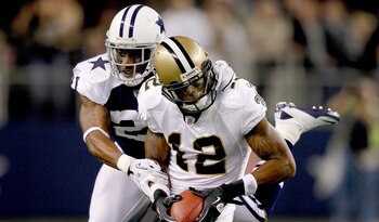ARLINGTON, TX - NOVEMBER 25: Mike Jenkins #21 of the Dallas Cowboys tackles Marques Colston #12 of the New Orleans Saints at Cowboys Stadium on November 25, 2010 in Arlington, Texas.  (Photo by Matthew Stockman/Getty Images)