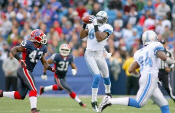 ORCHARD PARK, NY - NOVEMBER 14: Calvin Johnson #81 of the Detroit Lions makes a catch behind Bryan Scott #43 of the Buffalo Bills  at Ralph Wilson Stadium on November 14, 2010 in Orchard Park, New York. Buffalo won 14-12. (Photo by Rick Stewart/Getty Imag