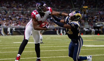 ST. LOUIS - NOVEMBER 21: Roddy White #84 of the Atlanta Falcons stiff arms Jerome Murphy #23 of the St. Louis Rams at the Edward Jones Dome on November 21, 2010 in St. Louis, Missouri.  The Falcons beat the Rams 34-17.  (Photo by Dilip Vishwanat/Getty Ima