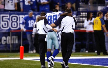 INDIANAPOLIS, IN - DECEMBER 05: Dez Bryant #88 of the Dallas Cowboys is helped off the field after an injury against the Indianapolis Colts at Lucas Oil Stadium on December 5, 2010 in Indianapolis, Indiana. The Cowboys defeated the Colts 38-35 in overtime
