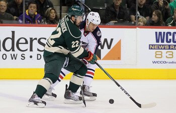ST PAUL, MN - OCTOBER 16:  Cal Clutterbuck #22 of the Minnesota Wild and Marc Methot #3 of the Columbus Blue Jackets battle for the puck at Xcel Energy Center on October 16, 2010 in St Paul, Minnesota.  (Photo by Jeff Gross/Getty Images)