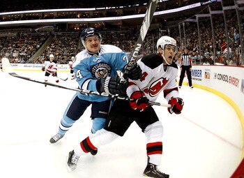 PITTSBURGH, PA - DECEMBER 06:  Matt Cooke #24 of the Pittsburgh Penguins checks Mark Fayne #34 of the New Jersey Devils at Consol Energy Center on December 6, 2010 in Pittsburgh, Pennsylvania.  The Penguins defeated the Devils 2-1.(Photo by Justin K. Alle