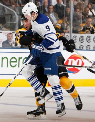 TORONTO, CANADA - DECEMBER 4: Colby Armstrong #9 of the Toronto Maple Leafs runs into Blake Wheeler #26 of the Boston Bruins during game action at the Air Canada Centre December 4, 2010 in Toronto, Ontario, Canada. (Photo by Abelimages / Getty Images)
