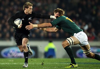 AUCKLAND, NEW ZEALAND - JULY 10:  Cory Jane of the All Blacks makes a break during the Tri-Nations match between the New Zealand All Blacks and South Africa Springboks at Eden Park on July 10, 2010 in Auckland, New Zealand.  (Photo by Hannah Johnston/Gett