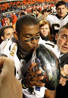 MIAMI GARDENS, FL - FEBRUARY 07:  Head coach Sean Payton of the New Orleans Saints reaches out to have Marques Colston #12 kiss the Vince Lombardi Trophy after defeating the Indianapolis Colts during Super Bowl XLIV on February 7, 2010 at Sun Life Stadium