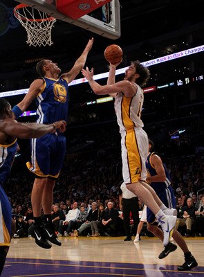LOS ANGELES - NOVEMBER 21:   Pau Gasol #16 of the Los Angeles Lakers shoots over Andris Biedrins #15 of the Golden State Warriors at Staples Center on November 21, 2010 in Los Angeles, California.   NOTE TO USER: User expressly acknowledges and agrees tha