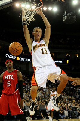 OAKLAND, CA - FEBRUARY 21:  Andris Biedrins #15 of the Golden State Warriors shoots against Josh Smith #5 of the Atlanta Hawks during an NBA game at Oracle Arena on February 21, 2010 in Oakland, California.  NOTE TO USER: User expressly acknowledges and a