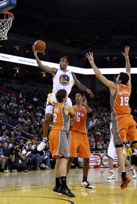 OAKLAND, CA - DECEMBER 02:  Monta Ellis #8 of the Golden State Warriors drives to the basket against the Phoenix Suns at Oracle Arena on December 2, 2010 in Oakland, California. NOTE TO USER: User expressly acknowledges and agrees that, by downloading and