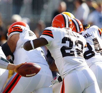 PITTSBURGH - OCTOBER 17: Colt McCoy #12 of the Cleveland Browns hands the ball off to teammate Mike Bell #22 during the game against the Pittsburgh Steelers on October 17, 2010 at Heinz Field in Pittsburgh, Pennsylvania.  (Photo by Jared Wickerham/Getty I
