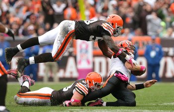 CLEVELAND - OCTOBER 03:  Linebackers Matt Roth #53 and Marcus Benard #58 of the Cleveland Browns sack quarterback Carson Palmer #9 of the Cincinnati Bengals at Cleveland Browns Stadium on October 3, 2010 in Cleveland, Ohio.  (Photo by Matt Sullivan/Getty