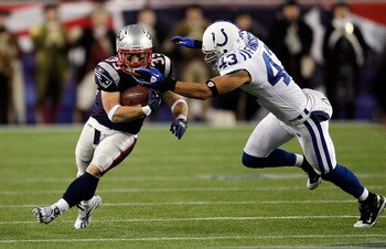 FOXBORO, MA - NOVEMBER 21:  Danny Woodhead #39 of the New England Patriots gains yards despite the defense of Aaron Francisco #43 of the Indianapolis Colts at Gillette Stadium on November 21, 2010 in Foxboro, Massachusetts. The Patriots won 31-28. (Photo