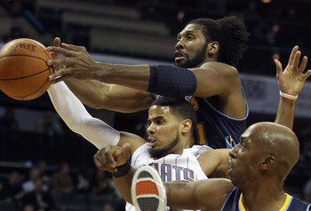 CHARLOTTE, NC - DECEMBER 07:  Teammates Nene #31 and Chauncey Billups #1 of the Denver Nuggets try to stop D.J. Augustin #14 of the Charlotte Bobcats during their game at Time Warner Cable Arena on December 7, 2010 in Charlotte, North Carolina.  NOTE TO U