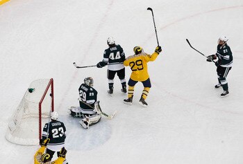 ANN ARBOR, MI - DECEMBER 11: Louie Capourusso #29 of the Michigan Wolverines celebrates teammates Jon Merrill #24 first goal of the game against the Michigan State Spartans during the Big Chill game at Michigan Stadium on December 11, 2010 in Ann Arbor, M