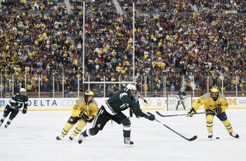 ANN ARBOR, MI - DECEMBER 11: Brett Perlini #11 of the Michigan State Spartans passes to a teamate in front of A.J. Treais #21 and Luke Moffatt #9 of the Michigan Wolverines at Michigan Stadium on December 11, 2010 in Ann Arbor, Michigan.  (Photo by Gregor