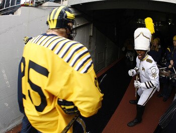 ANN ARBOR, MI - DECEMBER 11:  David Wohlberg #25 of the Michigan Wolverines passes the Michigan Marching Band prior to playing the Michigan State Spartans at Michigan Stadium on December 11, 2010 in Ann Arbor, Michigan.  (Photo by Gregory Shamus/Getty Ima