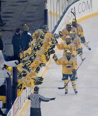 ANN ARBOR, MI - DECEMBER 11: Carl Hagelin #12 of the Michigan Wolverines celebrates with his teamates after scoring in the second period of the Big Chill game between the Michigan State Spartans and the Michigan Wolverines at Michigan Stadium on December