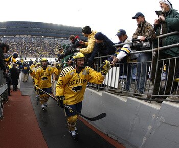 ANN ARBOR, MI - DECEMBER 11: Luke Glendening #23 of the Michigan Wolverines high fives fans after warmups prior to playing Michigan State at Michigan Stadium on December 11, 2010 in Ann Arbor, Michigan.  (Photo by Gregory Shamus/Getty Images)