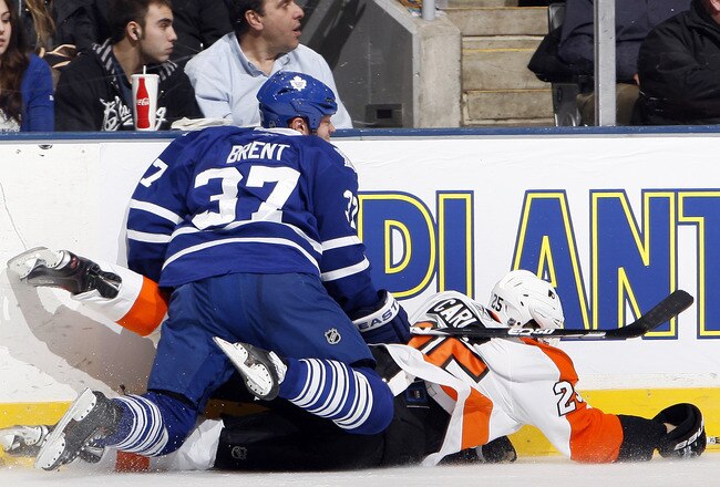 TORONTO, CANADA - DECEMBER 9: Tim Brent #37 of the Toronto Maple Leafs runs into Matt Carle #25 of the Philadelphia Flyers during game action at the Air Canada Centre December 9, 2010 in Toronto, Ontario, Canada. (Photo by Abelimages/Getty Images)