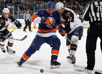 UNIONDALE, NY - DECEMBER 11:  Zenon Konopka #28 of the New York Islanders wins a face off from Jim Slater #23 of the Atlanta Thrashers on December 11, 2010 at Nassau Coliseum in Uniondale, New York.  (Photo by Jim McIsaac/Getty Images)