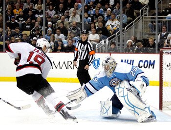 PITTSBURGH, PA - DECEMBER 06:  Marc-Andre Fleury #29 of the Pittsburgh Penguins poke checks Travis Zajac #19 of the New Jersey Devils at Consol Energy Center on December 6, 2010 in Pittsburgh, Pennsylvania.  (Photo by Justin K. Aller/Getty Images)