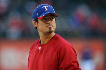 ARLINGTON, TX - OCTOBER 15:  Jorge Cantu #8 of the Texas Rangers looks on during batting practice against the New York Yankees in Game One of the ALCS during the 2010 MLB Playoffs at Rangers Ballpark in Arlington on October 15, 2010 in Arlington, Texas.  
