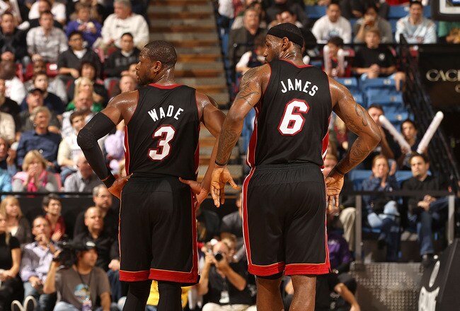 SACRAMENTO, CA - DECEMBER 11: Dwyane Wade #3 and LeBron James #6 of the Miami Heat stand on to the court during the shooting of a technical foul during their game against the Sacramento Kings at ARCO Arena on December 11, 2010 in Sacramento, California. N