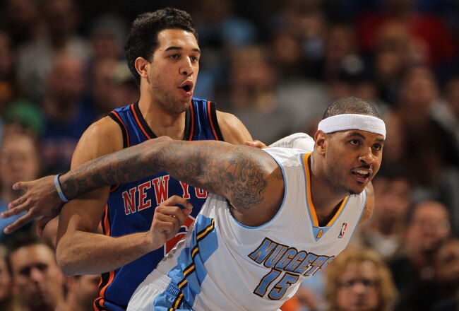 DENVER - NOVEMBER 16:  Carmelo Anthony #15 of the Denver Nuggets fights for position with Landry Fields #6 of the New York Knicks at the Pepsi Center on November 16, 2010 in Denver, Colorado. NOTE TO USER: User expressly acknowledges and agrees that, by d