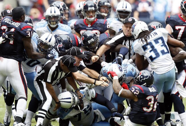 HOUSTON - NOVEMBER 28:  Officials attempt to separate players from both the Houston Texans and Tennessee Titans after a bench emptying brawl in the fourth quarter that was started by Andre Johnson of the Houston Texans and Cortland Finnegan of the Tenness