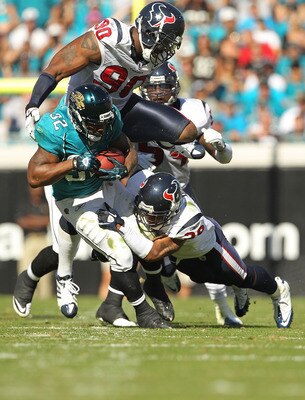 JACKSONVILLE, FL - NOVEMBER 14:  Maurice Jones-Drew #32 of the Jacksonville Jaguars is tackled by Glover Quin #29 during a game against the Houston Texans at EverBank Field on November 14, 2010 in Jacksonville, Florida.  (Photo by Mike Ehrmann/Getty Image