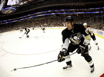 PITTSBURGH - NOVEMBER 10:  Ben Lovejoy #6 of the Pittsburgh Penguins clears the puck up the wall against the Boston Bruins at Consol Energy Center on November 10, 2010 in Pittsburgh, Pennsylvania.  The Bruins defeated the Penguins 7-4.(Photo by Justin K.