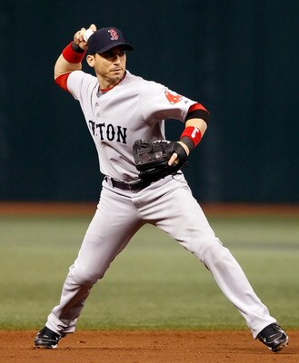 ST. PETERSBURG - AUGUST 29:  Shortstop Marco Scutaro #16 of the Boston Red Sox throws over to first for an out against the Tampa Bay Rays during the game at Tropicana Field on August 29, 2010 in St. Petersburg, Florida.  (Photo by J. Meric/Getty Images)