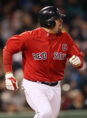 BOSTON - APRIL 16:  Jason Varitek #33 of the Boston Red Sox watches as his solo home run as he rounds the bases in the fifth inning against the Tampa Bay Rays on April 16, 2010 at Fenway Park in Boston, Massachusetts.  (Photo by Elsa/Getty Images)