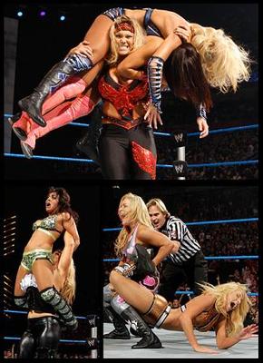 Strength and Domination: Beth and Natalya in action. How painful would be a Glam Slam through a table.