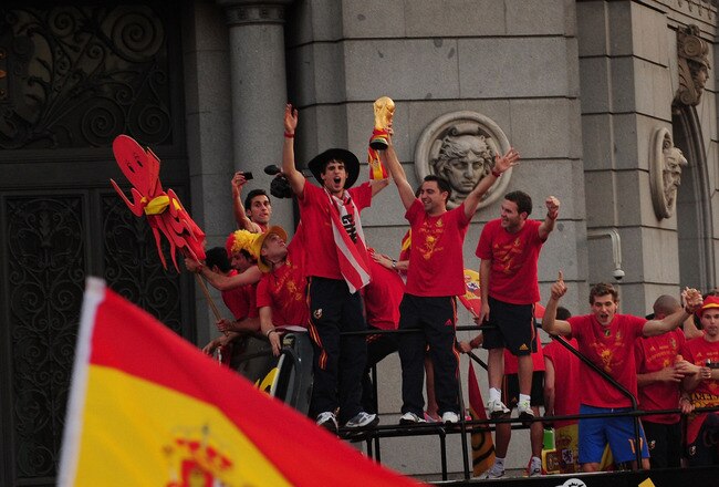 MADRID, SPAIN - JULY 12:  Xavi Hernandez holds aloft the FIFA World Cup to the crowds gathered in Plaza Cibeles on July 12, 2010 in Madrid, Spain after Spain won the FIFA World Cup.  (Photo by Denis Doyle/Getty Images)
