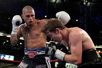 NEW YORK - JUNE 05:  (L-R) Miguel Cotto of Puerto Rico throws a left to the face of Yuri Foreman during the WBA world super welterweight title fight on June 5, 2010 at Yankee Stadium in the Bronx borough of New York City.  (Photo by Al Bello/Getty Images)
