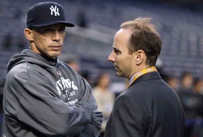 NEW YORK - OCTOBER 28:  Manager Joe Girardi (L) and General Manager Brian Cashman of the New York Yankees look on during batting practice against the Philadelphia Phillies in Game One of the 2009 MLB World Series at Yankee Stadium on October 28, 2009 in t