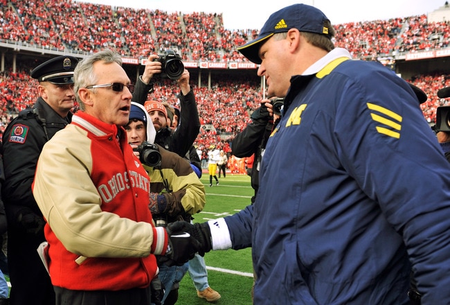 COLUMBUS, OH - NOVEMBER 27:  Head Coach Jim Tressel of the Ohio State Buckeyes shakes hands with Head Coach Rich Rodriguez after the Buckeyes defeated the Wolverines 37-7 at Ohio Stadium on November 27, 2010 in Columbus, Ohio.  (Photo by Jamie Sabau/Getty