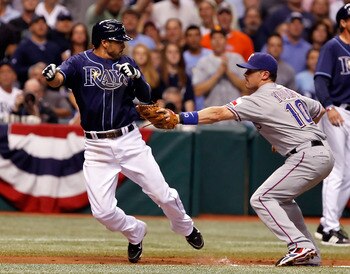 ST. PETERSBURG, FL - OCTOBER 12:  Infielder Jason Bartlett #8 of the Tampa Bay Rays is tagged out by Michael Young #10 of the Texas Rangers during Game 5 of the ALDS at Tropicana Field on October 12, 2010 in St. Petersburg, Florida.  (Photo by J. Meric/Ge