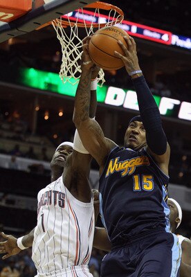 CHARLOTTE, NC - DECEMBER 07:  Carmelo Anthony #15 of the Denver Nuggets grabs a rebound over Stephen Jackson #1 of the Charlotte Bobcats during their game at Time Warner Cable Arena on December 7, 2010 in Charlotte, North Carolina.  NOTE TO USER: User exp