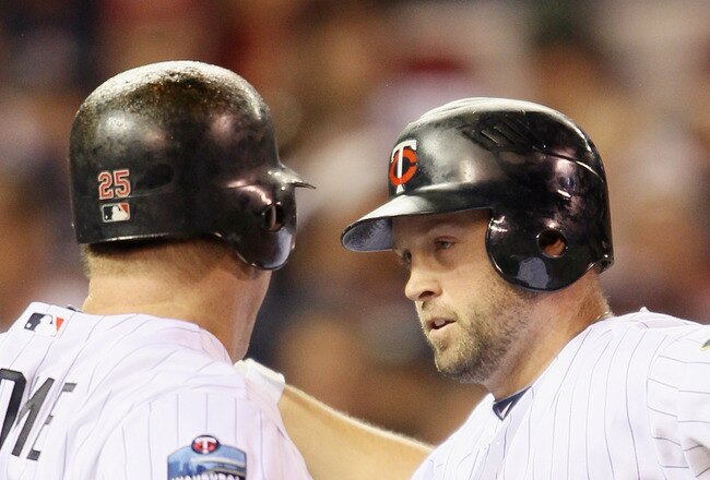 MINNEAPOLIS - OCTOBER 06:  Michael Cuddyer #5 of the Minnesota Twins celebrates his two run homer with teammate Jim Thome #25 in the second inning agianst the New York Yankees during game one of the ALDS on October 6, 2010 at Target Field in Minneapolis,