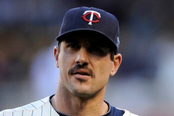MINNEAPOLIS, MN - OCTOBER 7: Starting pitcher Carl Pavano #48 and catcher Joe Mauer #7 of the Minnesota Twins walk to the dugout prior to game two of the ALDS game against the New York Yankees on October 7, 2010 at Target Field in Minneapolis, Minnesota.