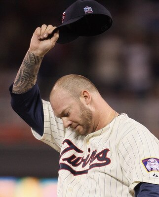 MINNEAPOLIS - OCTOBER 07:  Jon Rauch #60 of the Minnesota Twins wipes his brow against the New York Yankees during game two of the ALDS on October 7, 2010 at Target Field in Minneapolis, Minnesota.  (Photo by Elsa/Getty Images)