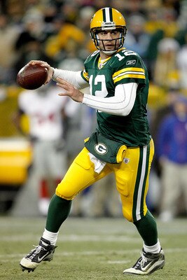 GREEN BAY, WI - DECEMBER 26:  Aaron Rodgers #12 of the Green Bay Packers rolls out of the pocket against the New York Giants at Lambeau Field on December 26, 2010 in Green Bay, Wisconsin.  (Photo by Matthew Stockman/Getty Images)