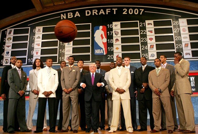 NEW YORK - JUNE 28: NBA Commissioner David Stern (C) throws a basketball at the media while posing with (L-R) Al Horford, Acie Law IV, Joakim Noah, Nick Young, Kevin Durant, Corey Brewer, Yi Jianlian, Greg den, Julian Wright, Rodney Stuckey, Spencer Hawes