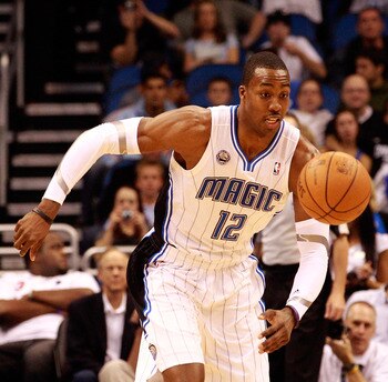 ORLANDO, FL - DECEMBER 18:  Dwight Howard #12 of the Orlando Magic chases down a loose ball during the game against the Philadelphia 76ers at Amway Arena on December 18, 2010 in Orlando, Florida.  NOTE TO USER: User expressly acknowledges and agrees that,