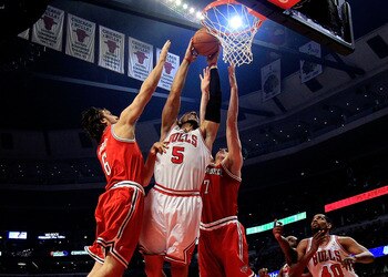 CHICAGO, IL - DECEMBER 28: Carlos Boozer #5 of the Chicago Bulls dunks the ball between Andrew Bogut #6 and Ersan Ilyasova #7 of the Milwaukee Bucks at the United Center on December 28, 2010 in Chicago, Illinois. NOTE TO USER: User expressly acknowledges