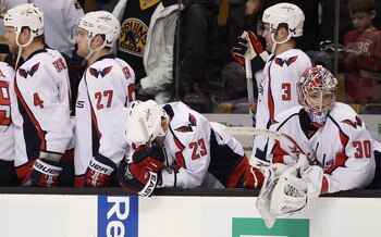 BOSTON, MA - DECEMBER 18:  John Erskine #4,Karl Alzner #27,Scott Hannan,Tom Poti #3 and Michal Neuvirth #30 of the Washington Captials watch the last seconds of the game against the Boston Bruins on December 18, 2010 at the TD Garden in Boston, Massachuse